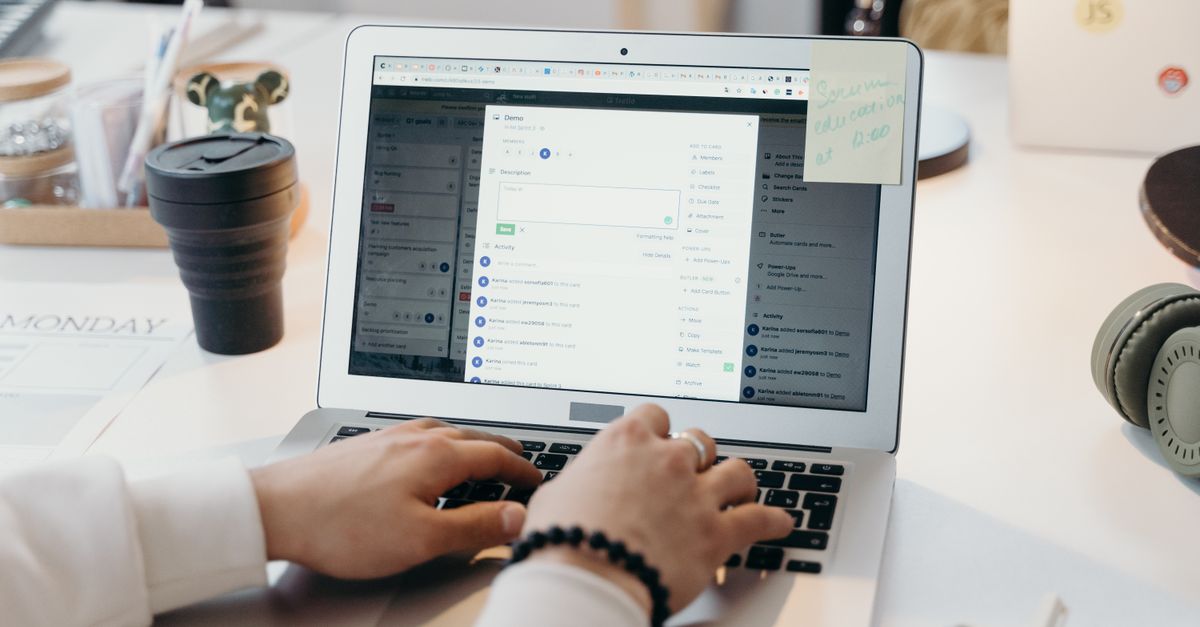Writing a restaurant email campaign on a laptop at a bright desk