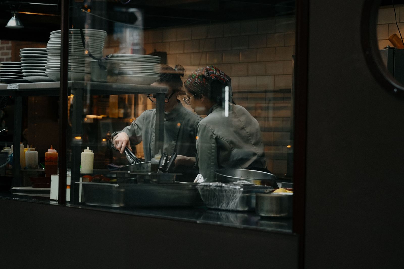 Chefs cooking during service in a busy restaurant kitchen