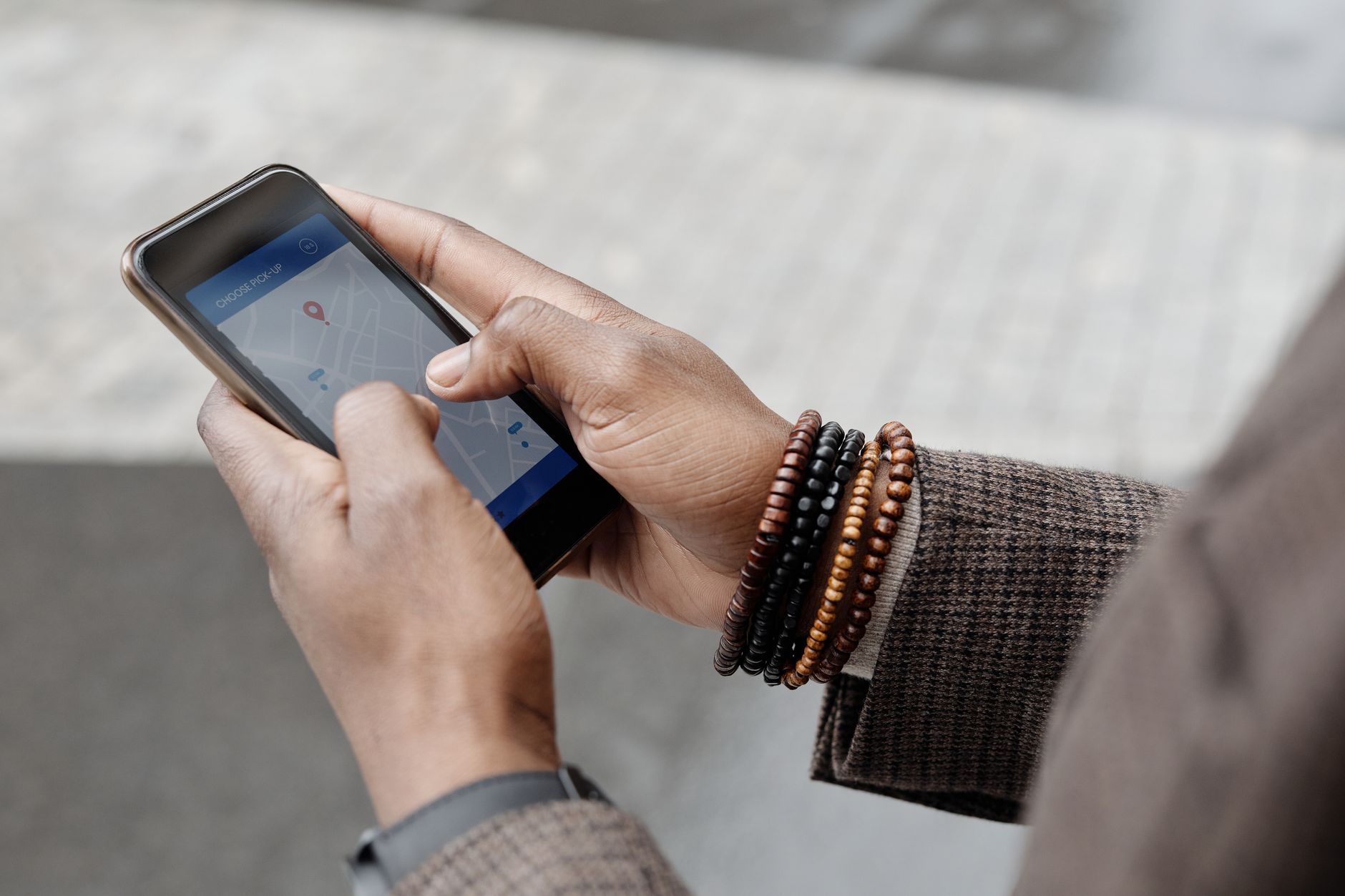 A diner using a maps app on a smartphone to find somewhere to eat